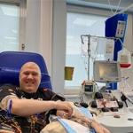 Man receives CAR-T cell therapy. He is sat down next to medical equipment