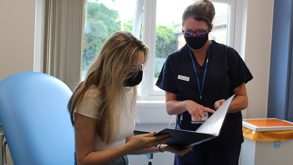 nurse speaks with trial participant at the EMCRF